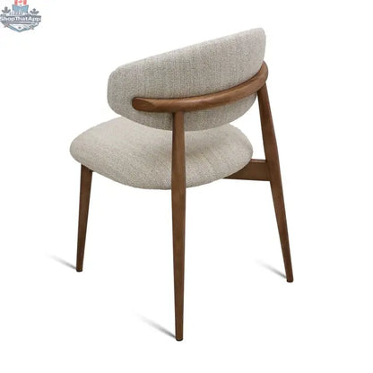 Beige fabric Cammy dining chair with walnut wood frame, shown from the back view, by Hygge Design House.