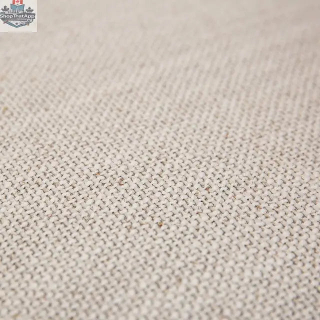 Close-up of Hygge Design House Cammy dining chair in beige fabric, showing textured upholstery and modern design details.