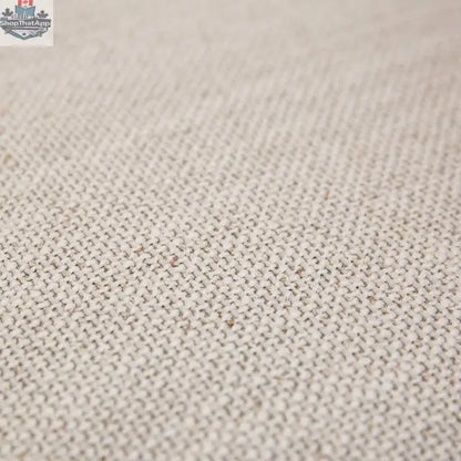 Close-up of Hygge Design House Cammy dining chair in beige fabric, showing textured upholstery and modern design details.