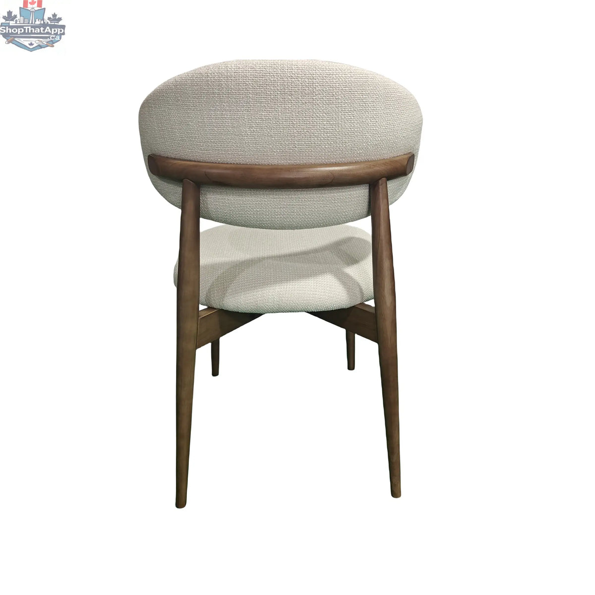 Rear view of Hygge Design House Cammy dining chair with beige fabric upholstery and walnut wood legs.