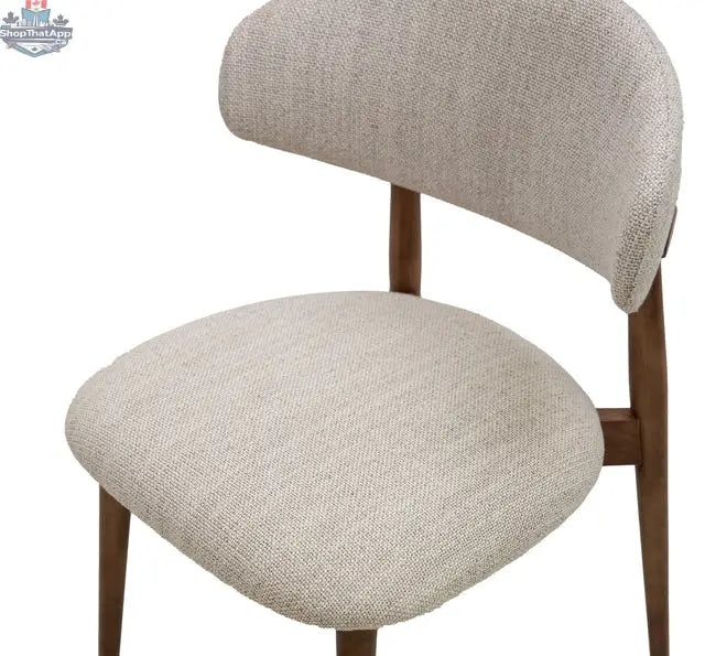 Beige fabric Cammy Dining Chair by Hygge Design House with a cushioned seat and backrest, showcasing stylish and comfortable dining furniture.