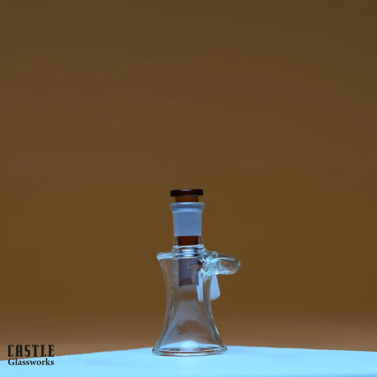 Castle Glassworks 14mm ash catcher for smooth smoking, featuring clear glass with intricate design and a 14mm joint.