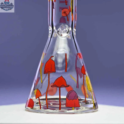 Close-up of 12-inch Castle Glassworks Shroomie beaker bong with thick 9mm glass, featuring a purple background and detailed base.