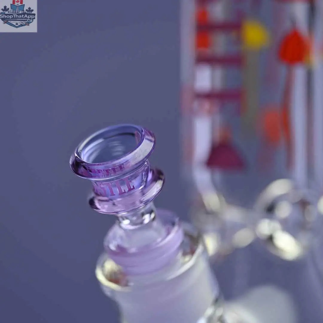 Close-up of Castle Glassworks 12-inch Shroomie beaker bong with purple background and clear glass bowl.