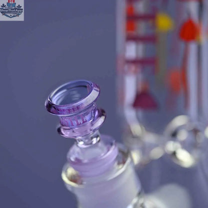 Close-up of Castle Glassworks 12-inch Shroomie beaker bong with purple background and clear glass bowl.