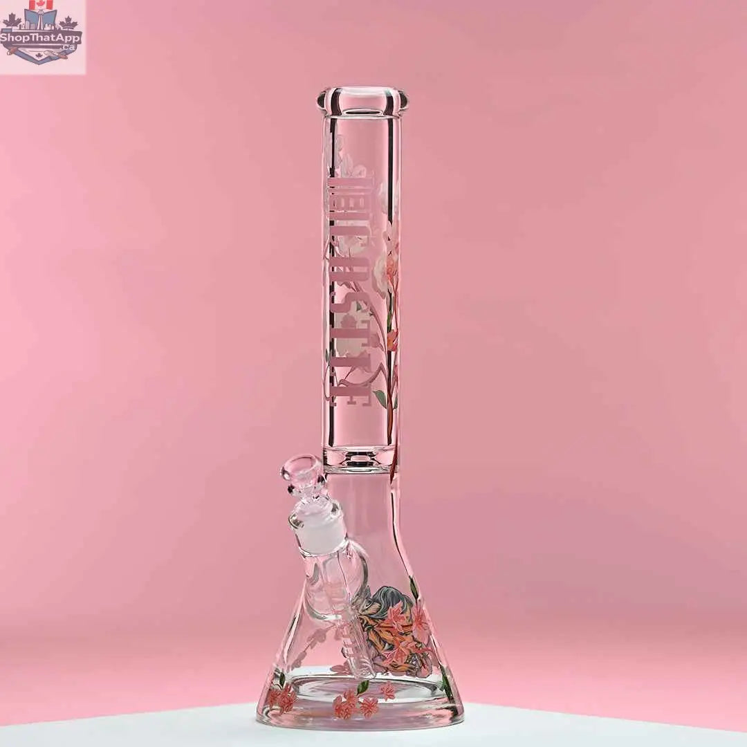 Castle Glassworks 16-inch cherry blossom beaker bong with 9mm thick glass and beaker design, set against a pink background.