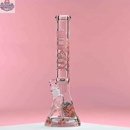 Castle Glassworks 16-inch cherry blossom beaker bong with 9mm thick glass and beaker design, set against a pink background.