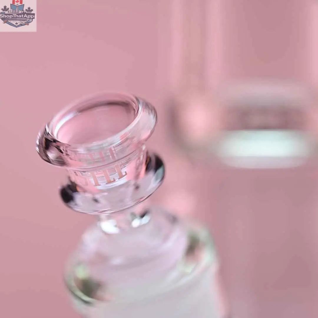 Close-up of 16-inch Cherry Blossom beaker bong by Castle Glassworks with pink background and detailed glass design.