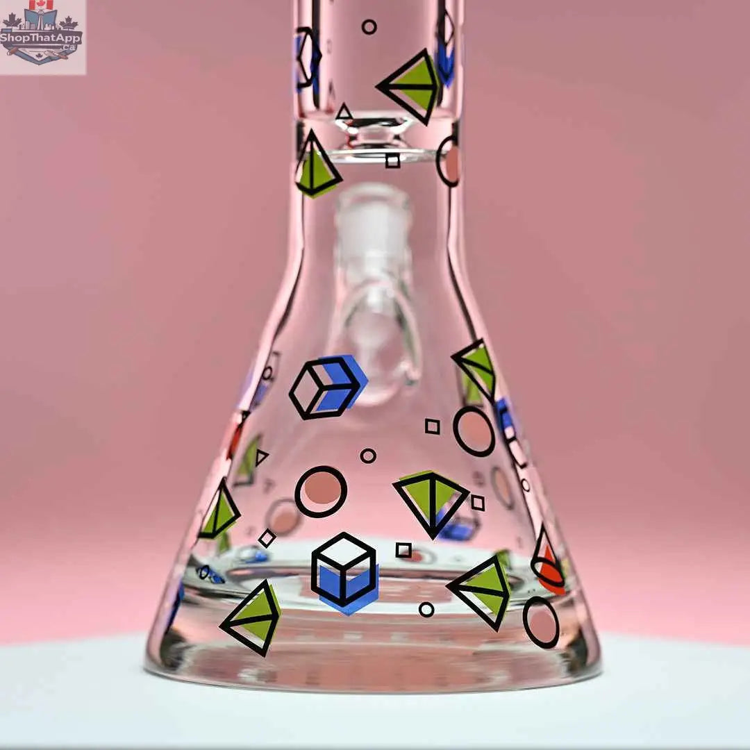 Close-up of Castle Glassworks 18-inch traditional beaker bong with a pink background, showing the glass base and detailed craftsmanship.