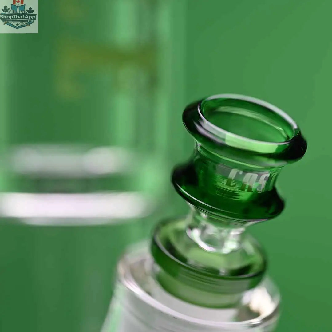 Castle Glassworks 14-inch beaker bong with green logo, featuring a 9-hole downstem and colorful background.