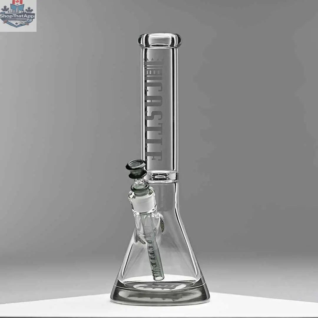 Castle Glassworks 14-inch beaker bong with colored logo, grey background, and 9-hole downstem replacement, showcasing its design.