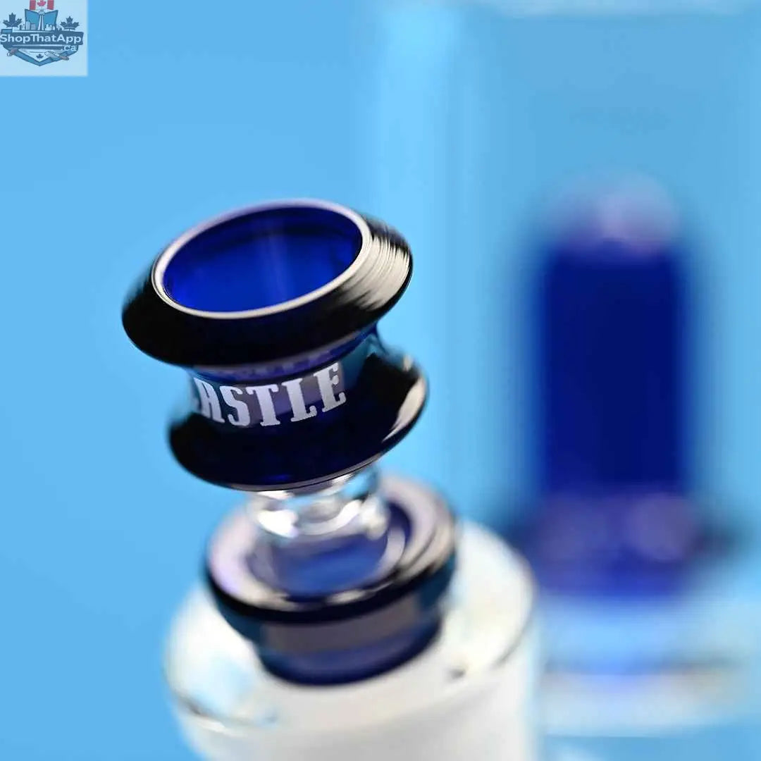 Blue beaker-style showerhead bong by Castle Glassworks with a blue background and detailed close-up of the bowl.