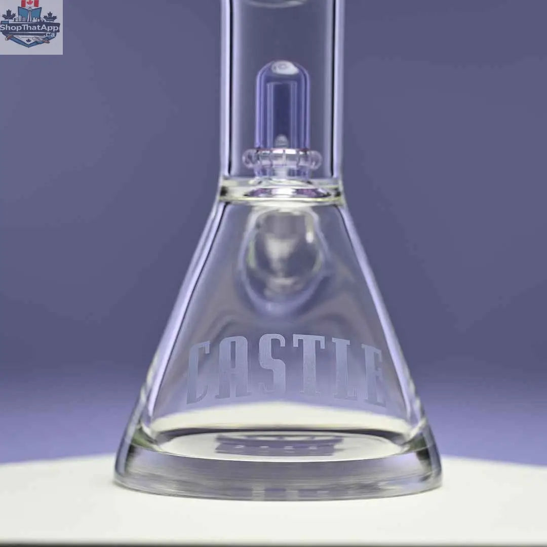 Purple Castle Glassworks beaker bong with dual showerhead percolators, close-up of base against purple background for smooth hits.