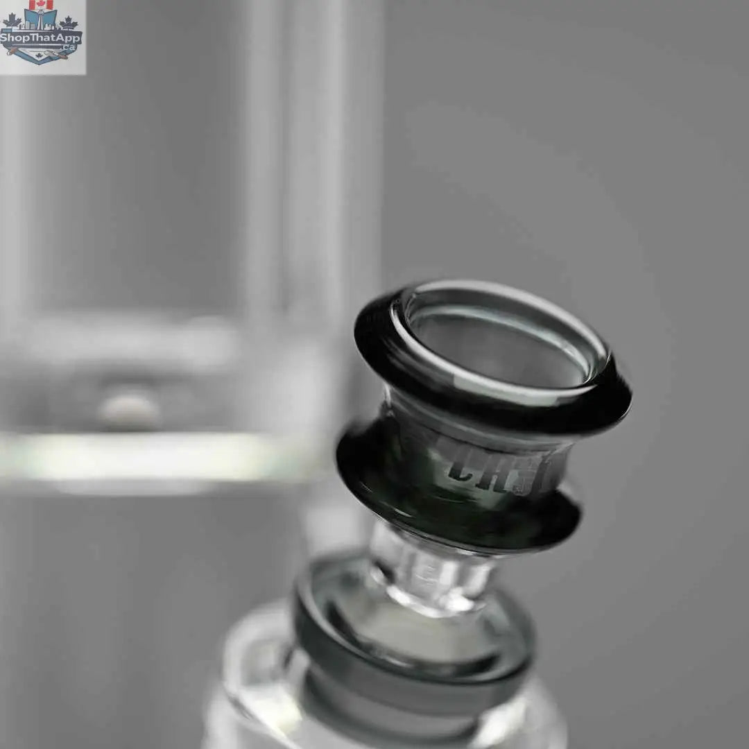 Close-up of Castle Glassworks 18-inch glass beaker bong with grey logo and thick 9mm glass, shown against a grey background.