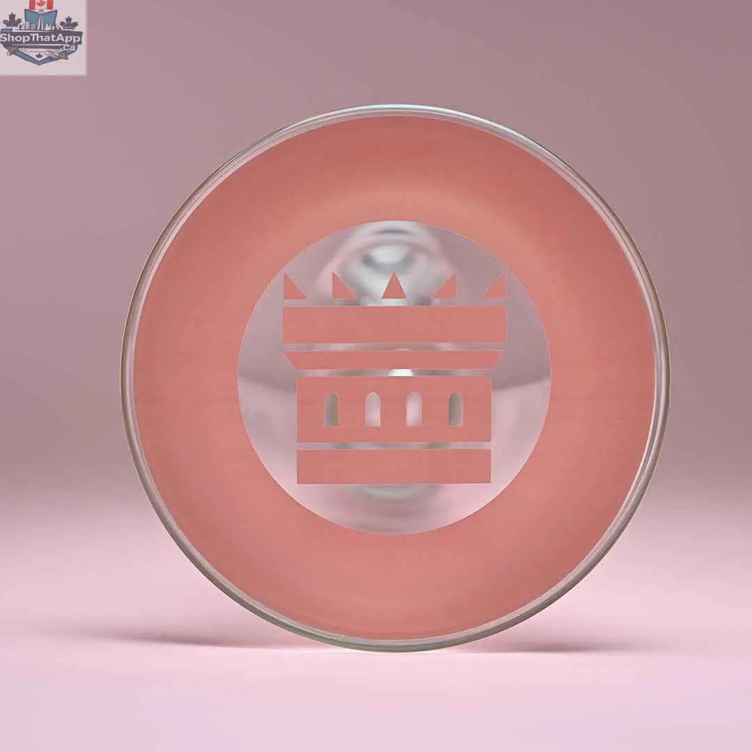Close-up of Castle Glassworks 18-inch beaker bong with pink logo, thick glass base, and colorful background.
