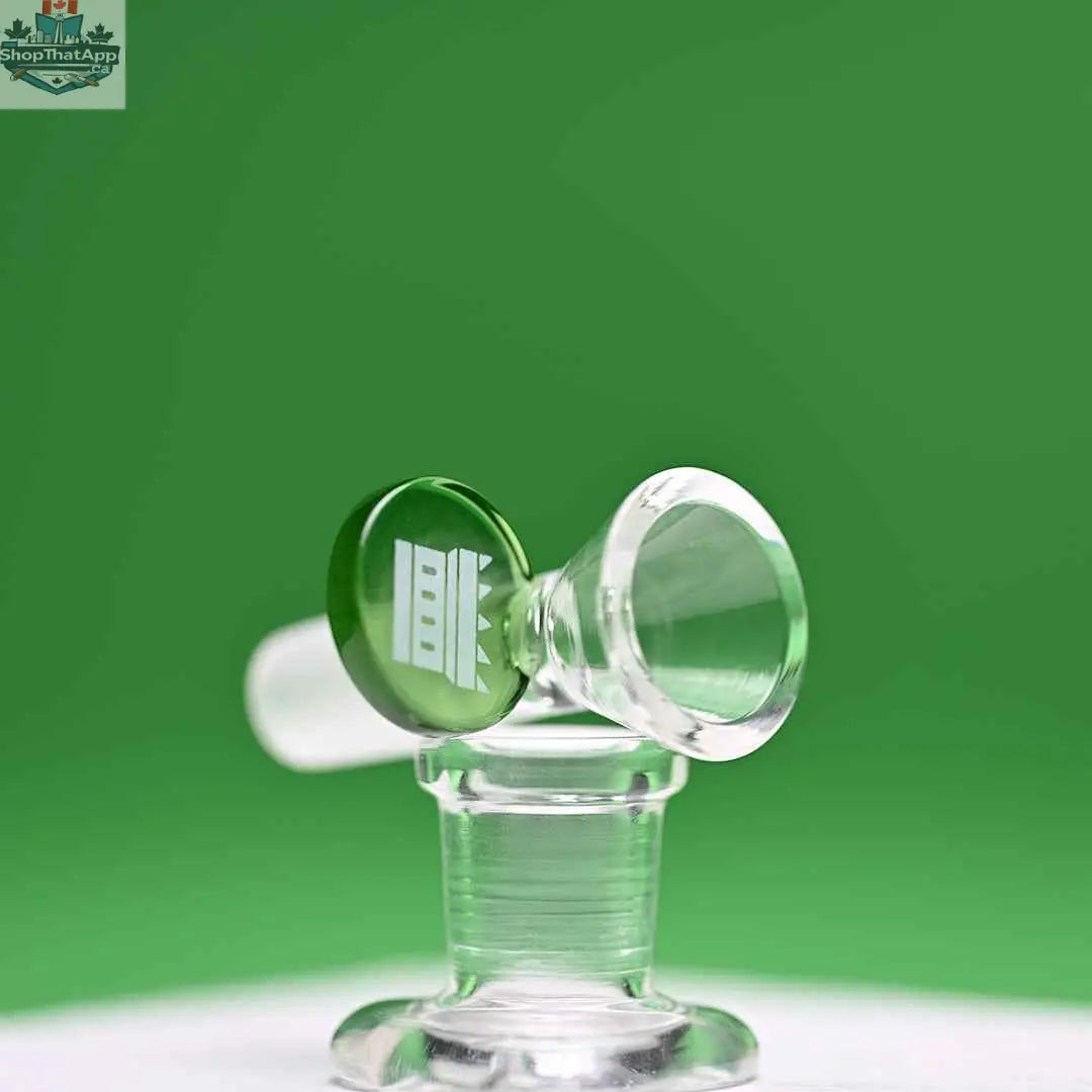 Green 14mm borosilicate glass round tab bowl by Castle Glassworks on a green background, showing the bowl's shape and design.
