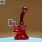 Red electroplated 7-inch high-performance mini dab rig by Castle Glassworks on an amber background.