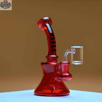 Red mini electroplated dab rig by Castle Glassworks with amber background, showcasing its compact high-performance design.