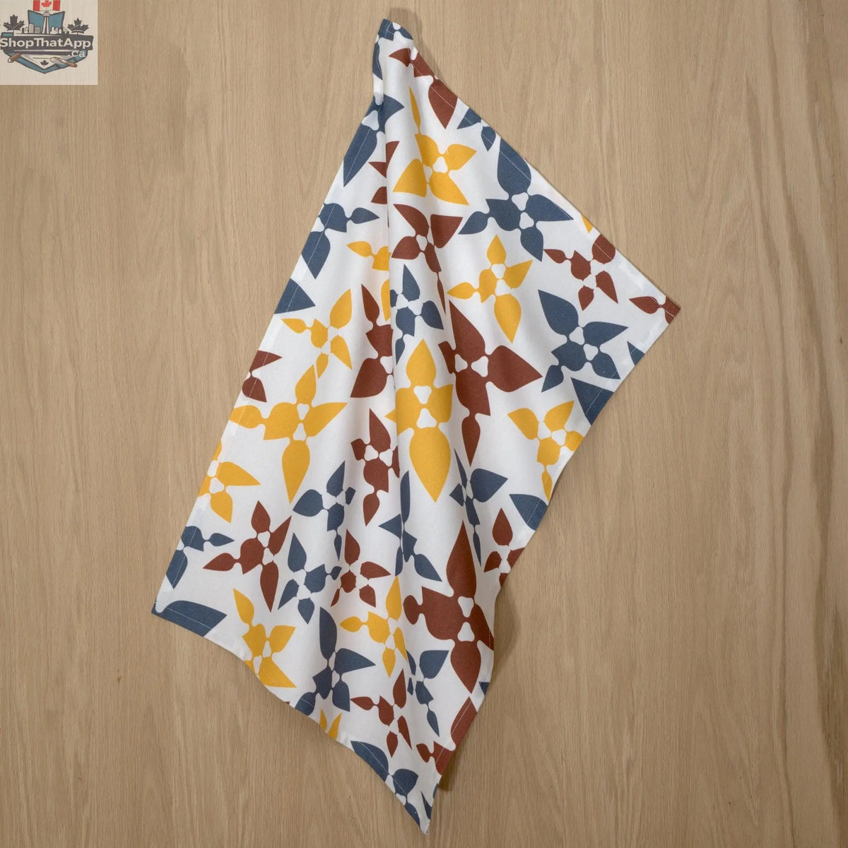 Hem And Tassel Celebration Cotton Tea Towels with printed design, hanging in a kitchen setting. Durable and decorative kitchen towels.