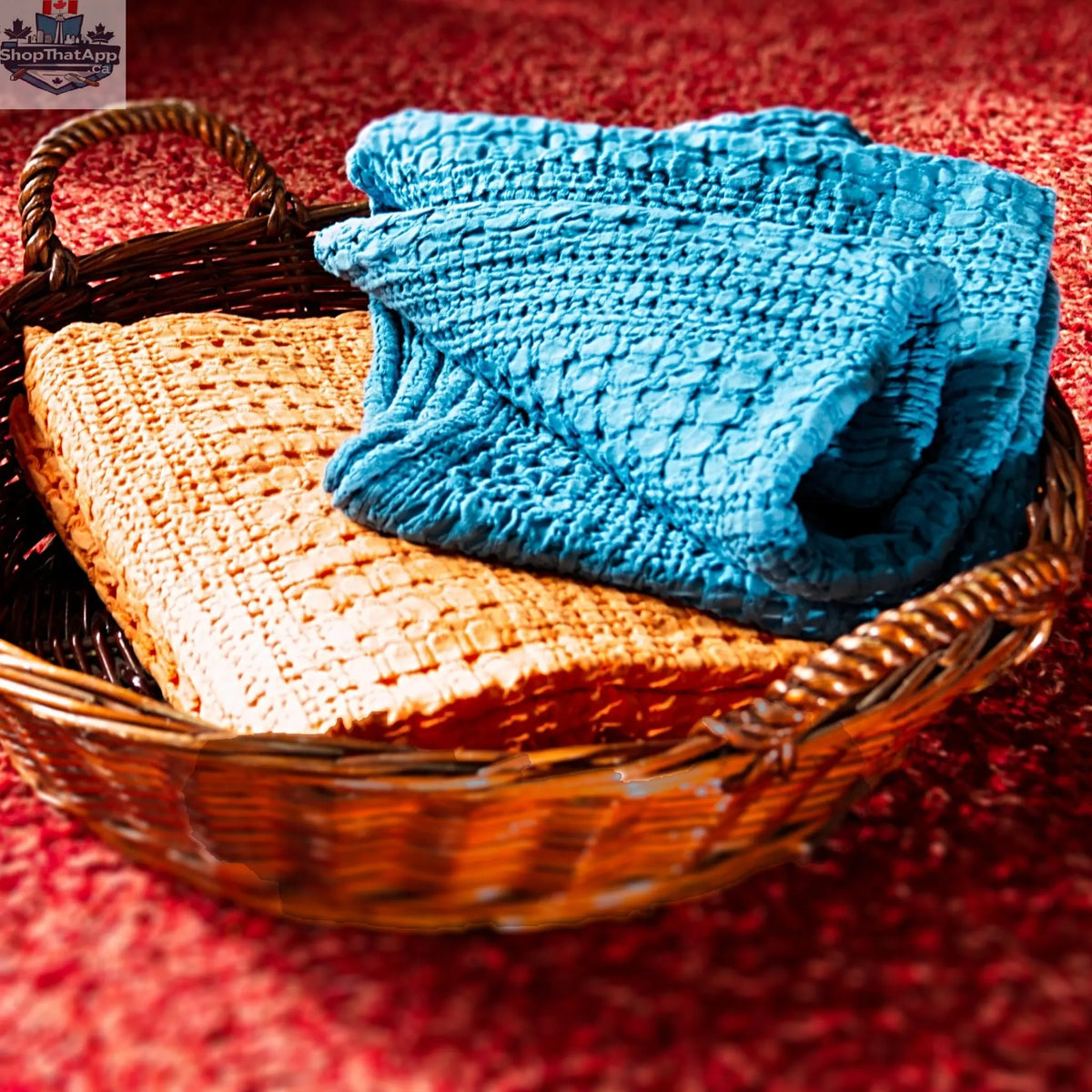 Hem And Tassel double-waffle cotton throw in orange and blue, shown in a basket with textured fabric and cozy appearance.