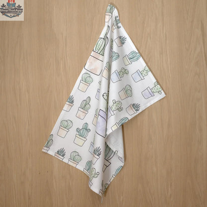 Desert Haze watercolor cactus printed kitchen towel hanging, featuring vibrant desert-themed artwork by Hem And Tassel.
