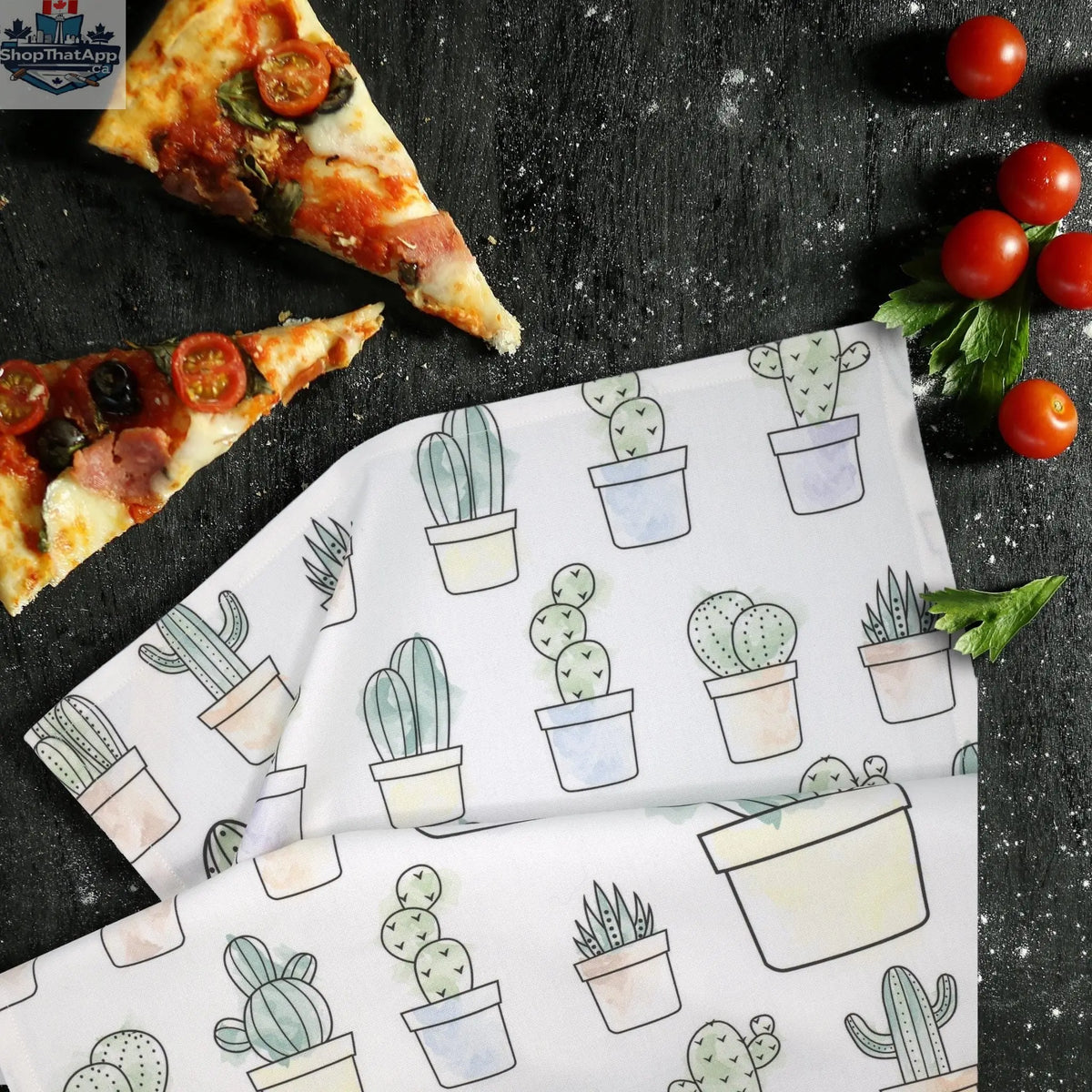 Printed kitchen towel featuring Desert Haze cacti watercolor artwork by Hem And Tassel, displayed on a kitchen counter.