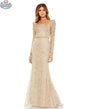 Light gold embroidered appliqué evening trumpet gown with elegant shoulder detail by Elegant Threads, shown on a model.