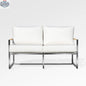 Enclover Acacia loveseat with white Sunbrella cushions, durable design, and comfortable seating for outdoor spaces.