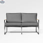 Enclover Acacia loveseat with durable frame and Sunbrella® cushions, featuring a slate-colored fabric and comfortable seating.