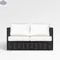 Enclover Chestnut loveseat with Sunbrella® cushions, featuring a cozy wooden frame and plush fabric cushions.