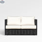 Chestnut loveseat by Enclover with Sunbrella® cushions, showcasing a cozy outdoor seating area with plush cushions and wooden frame.