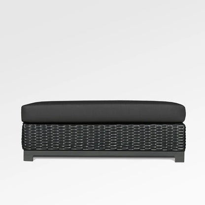 Enclover Trillium outdoor ottoman with Sunbrella Spectrum Carbon cushion, stylish and durable for outdoor seating and relaxation.