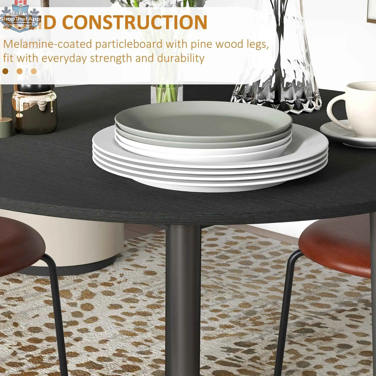 Black Merrill round drop-leaf dining table by SLOTH Nation, ideal for small spaces, shown in a modern home setting.