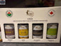 Four bottles of Golden Treasure Maple Syrup oak barrel aged maple syrup with front labels visible.
