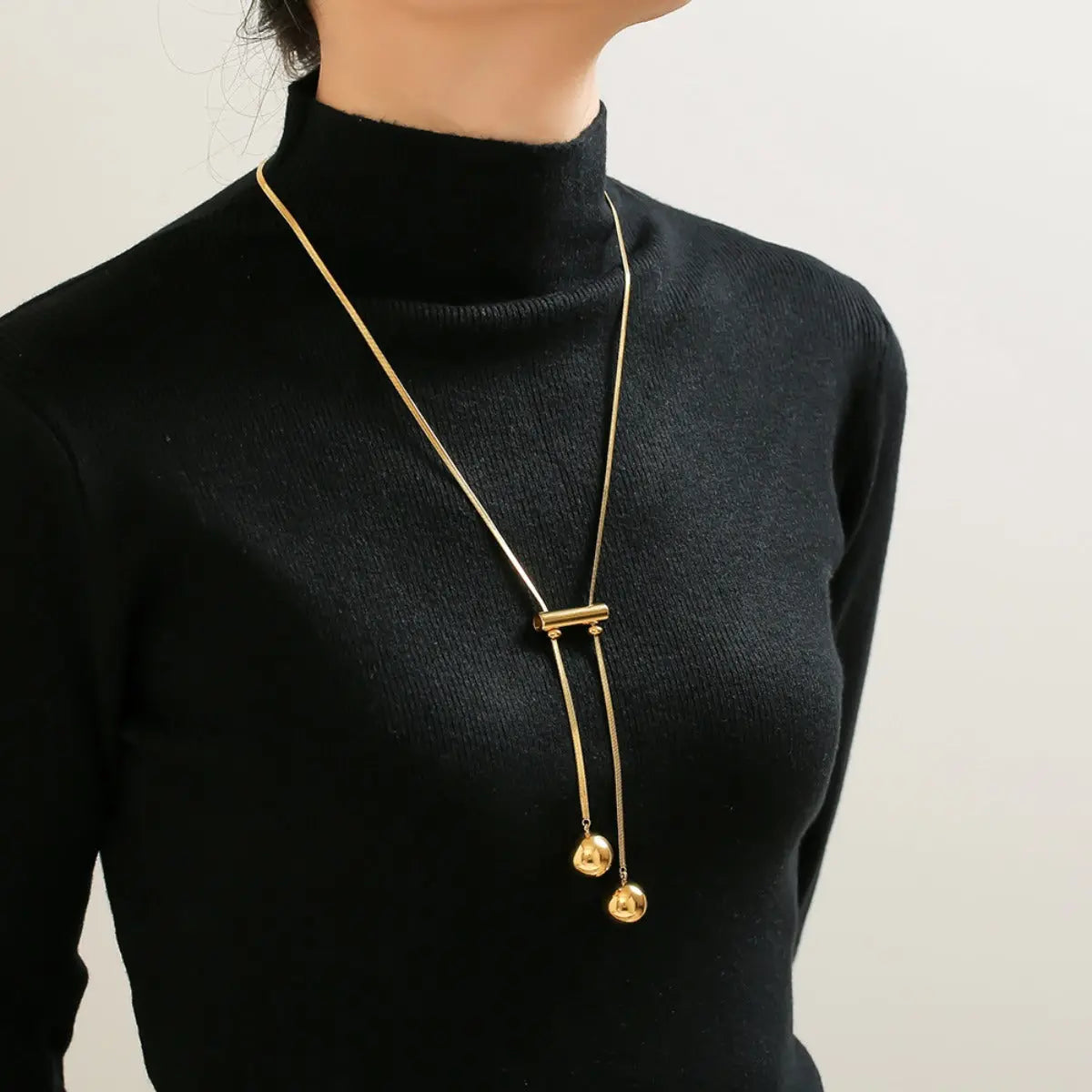 18K gold-plated titanium necklace featuring a hollow bead design, stylish and lightweight jewelry by harry'zBOUTIQUE.