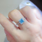 Sterling silver 2 carat moissanite square-shaped ring with elegant design, showcasing the sparkling gemstone and silver band.