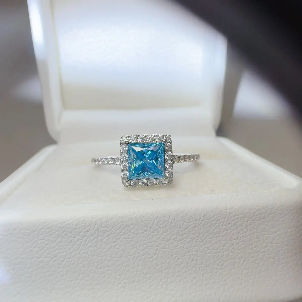 Sterling silver 2 carat moissanite ring with a square shape, featuring a sparkling center stone and elegant band design.