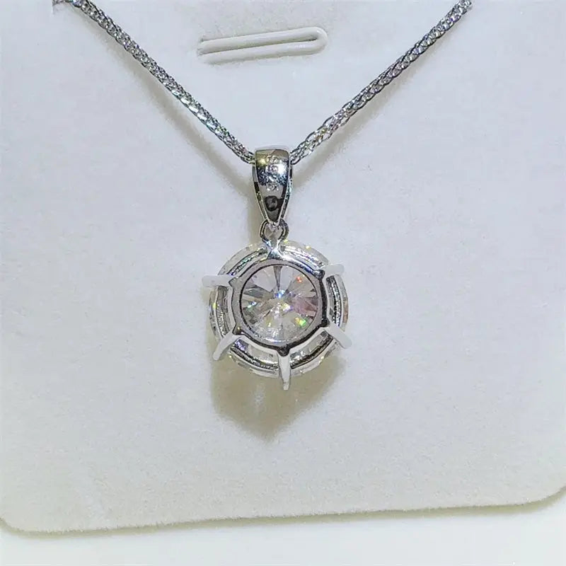 Sterling silver 10 carat moissanite necklace with pendant, showcasing sparkling gemstone and elegant chain design.