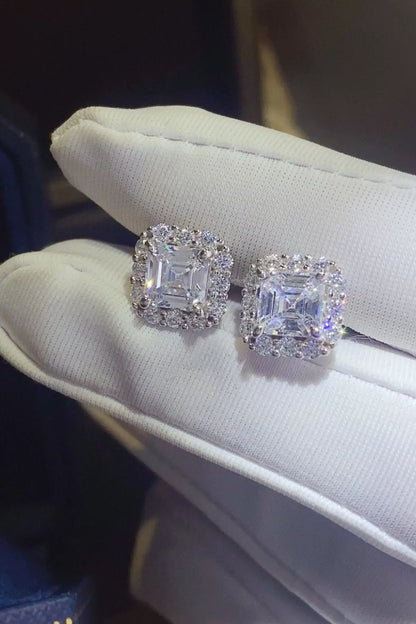 Two 2-carat moissanite stud earrings in sterling silver, showcasing sparkling gemstones and classic jewelry design