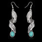 Turquoise alloy leaf earrings with stylish, elegant design, featuring detailed leaf shapes and a vibrant turquoise finish.