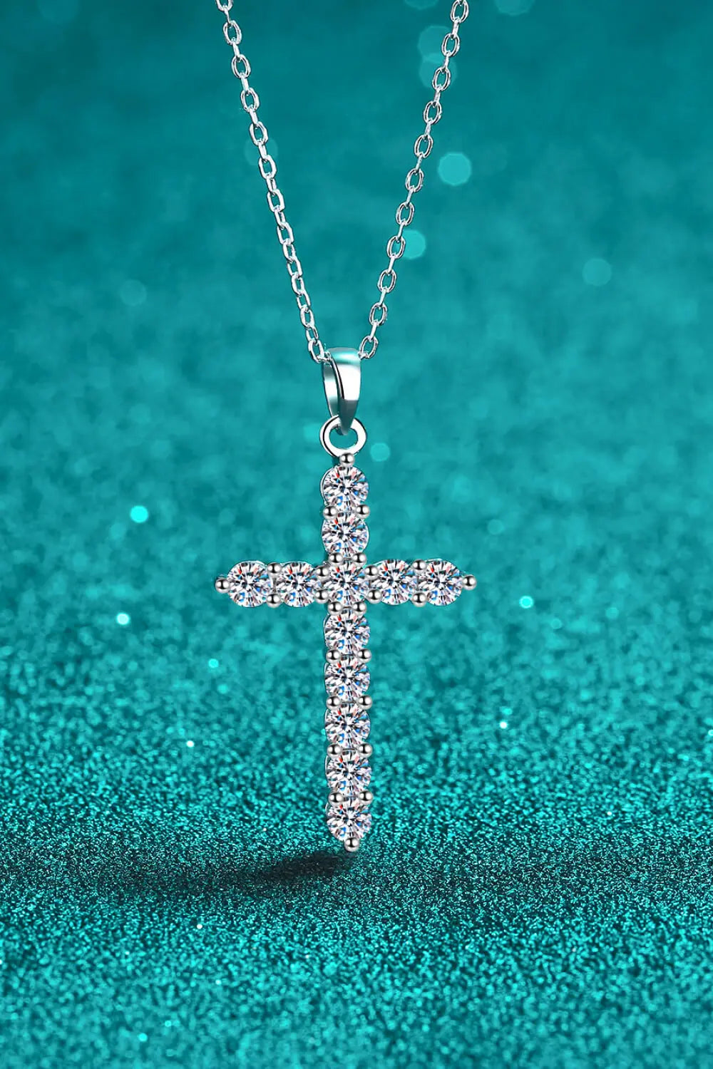 Sterling silver cross necklace with sparkling moissanite gemstones, elegant jewelry piece featuring intricate design and radiant shine.