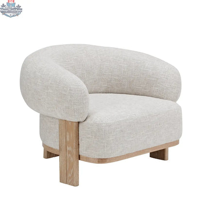 Cream textured fabric Konsta accent chair with a solid wood frame by Hygge Design House.