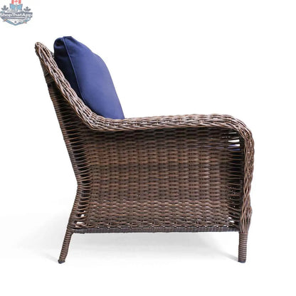 Krikacy Cambridge brown wicker outdoor club chair with indigo cushions, stylish patio seating for outdoor relaxation.