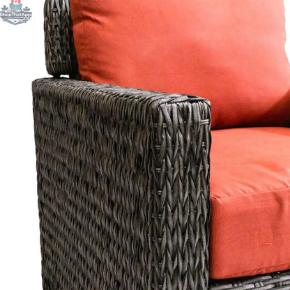 Brown Laguna Point wicker club chair by Krikacy with orange cushions, perfect for stylish outdoor patio relaxation.