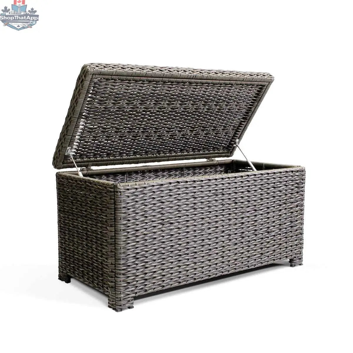 Open Laguna Point wicker outdoor storage chest coffee table by Krikacy with park meadow wicker chair in a backyard setting.