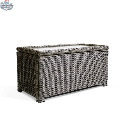 Krikacy Laguna Point brown wicker outdoor storage chest coffee table with park meadows wicker chair in a patio setting
