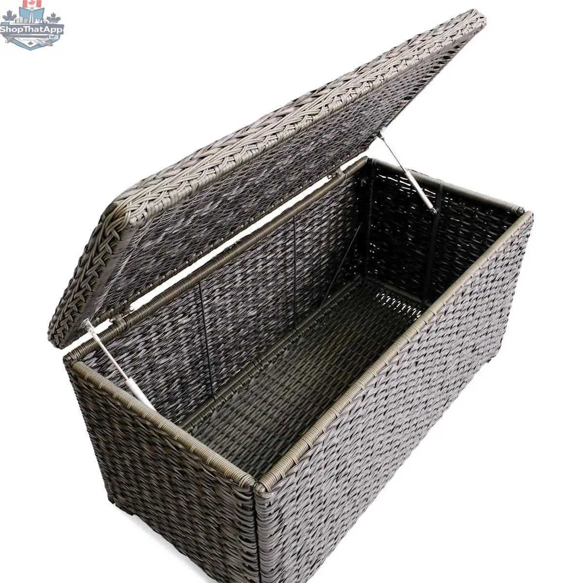 Krikacy Laguna Point brown wicker outdoor storage chest coffee table with park meadows wicker chair in a patio setting