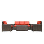 Krikacy Laguna Point outdoor wicker conversational set with four pieces, featuring brown furniture and orange cushions.