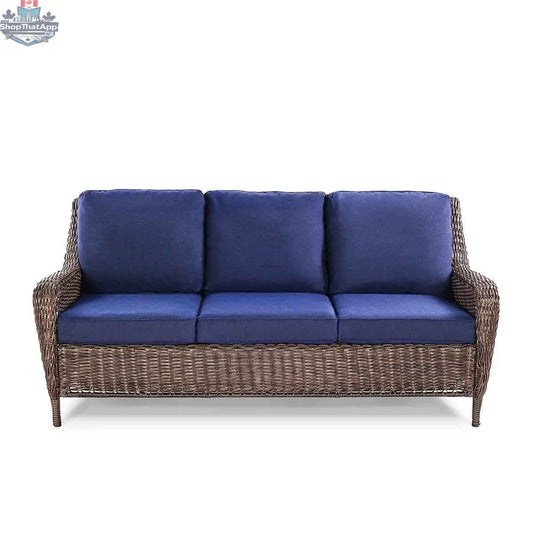 Krikacy Cambridge wicker outdoor loveseat sofa with brown wicker frame and indigo cushions, front view.