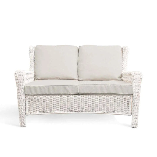 Krikacy Park Meadows white wicker loveseat for outdoor seating, featuring plush cushions and a stylish, durable design for outdoor comfort.